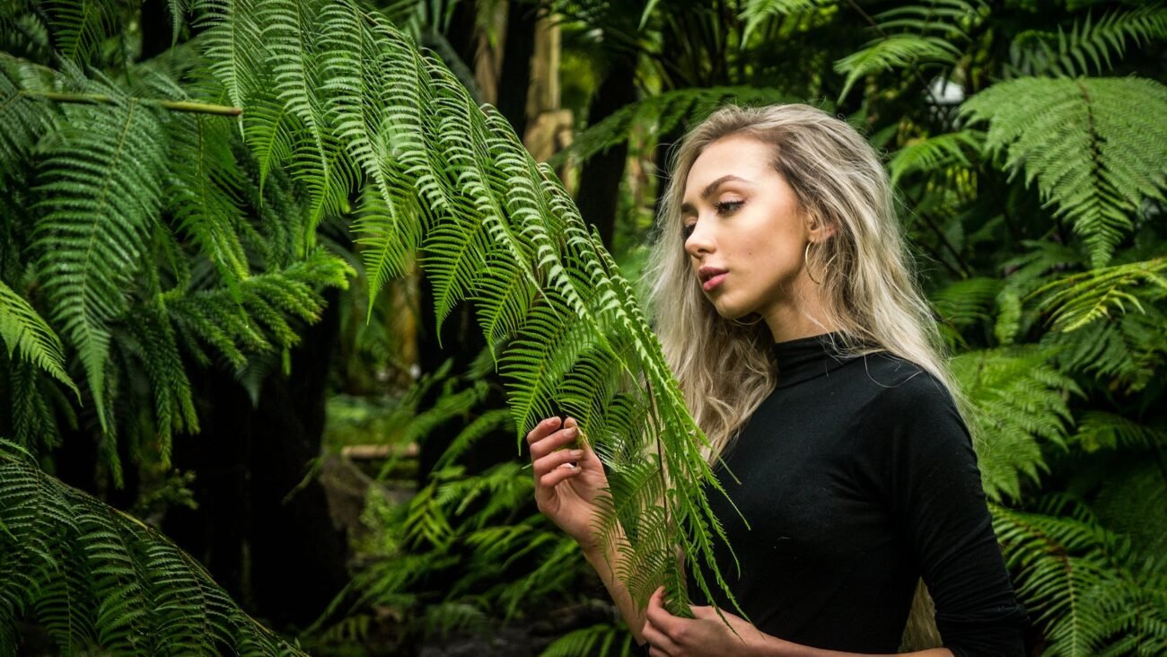 photo of girl holding fern