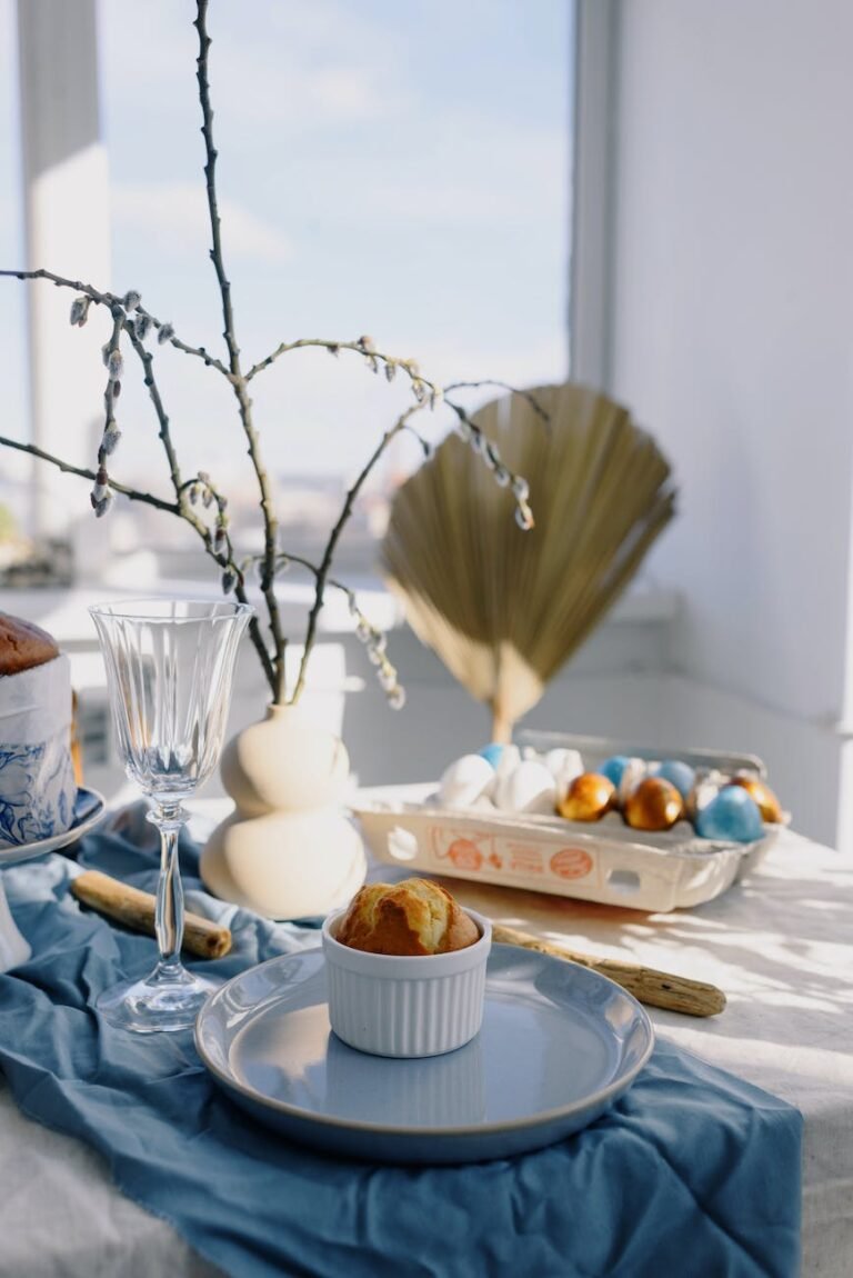 easter composition with eggs and cakes on table against window