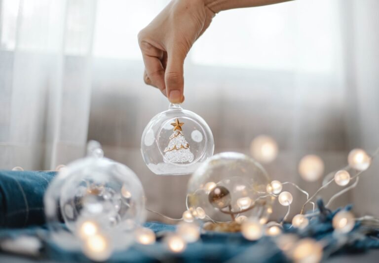 person preparing glass ball for christmas decoration