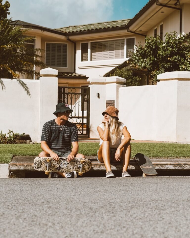 young people sitting on a curb