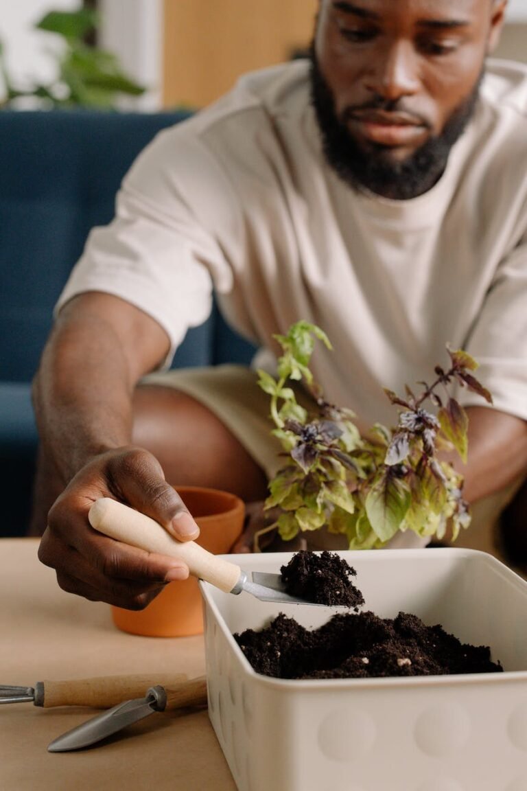 man scooping soil with a trowel