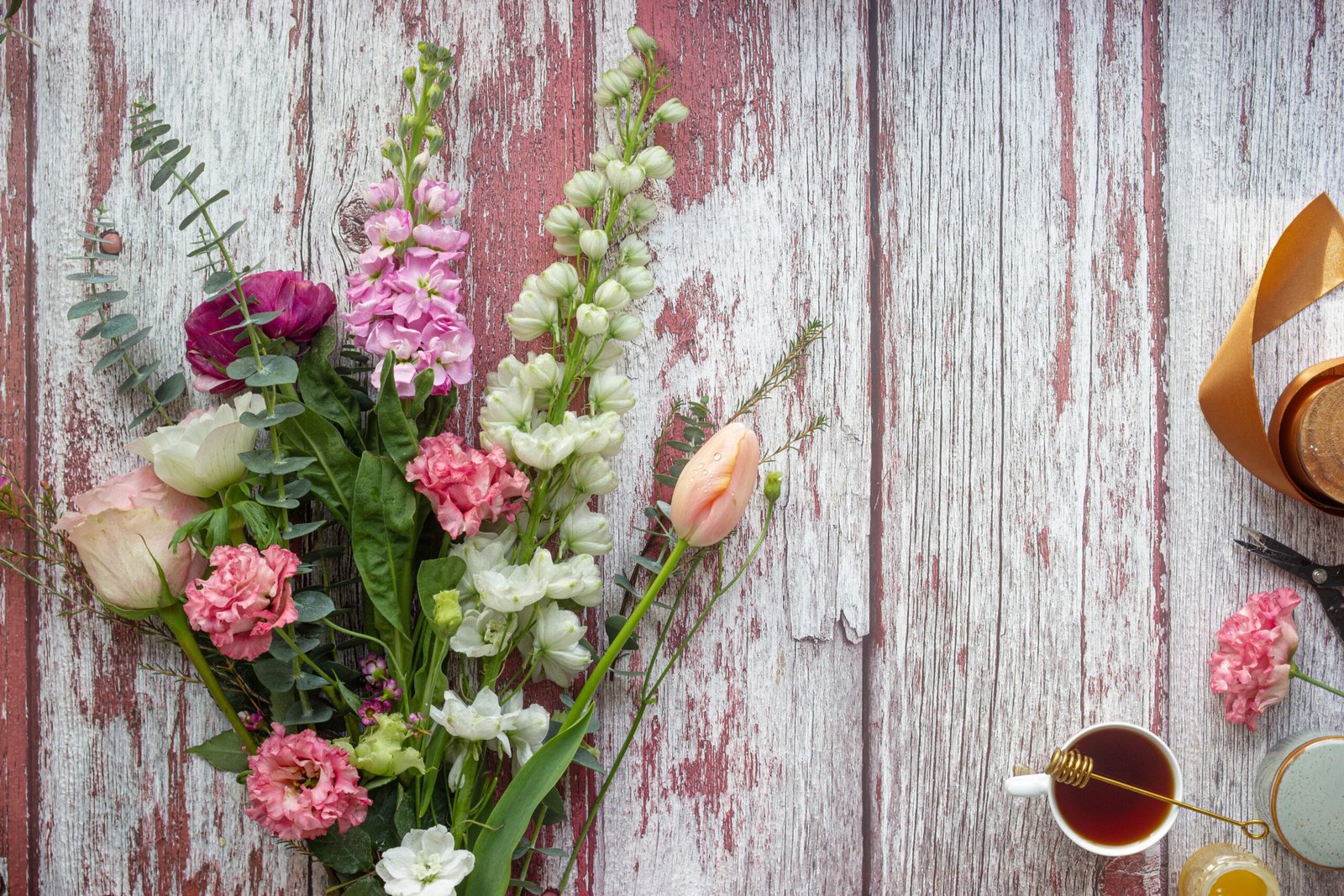 pink flower on gray wooden plank