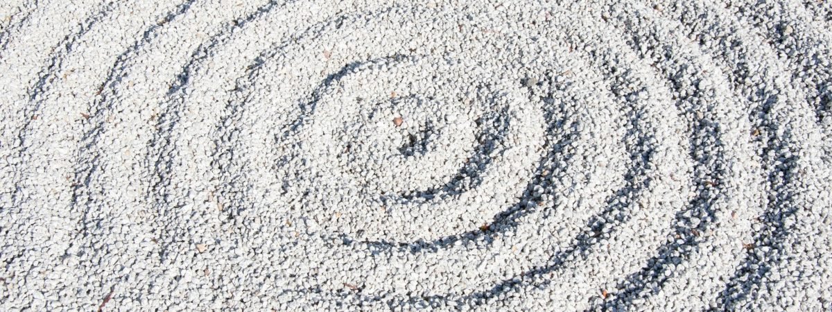 a circular design made of sand on a beach