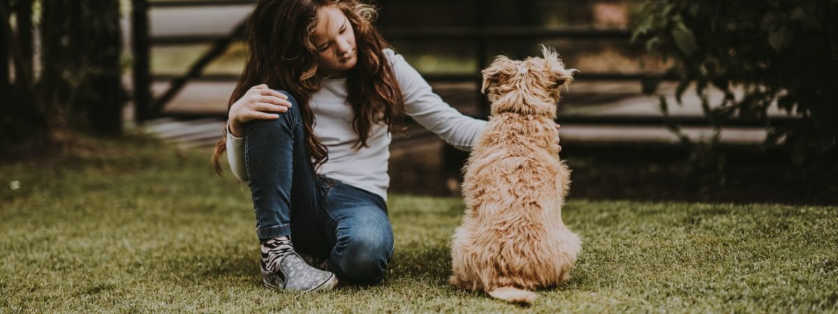 girl petting dog