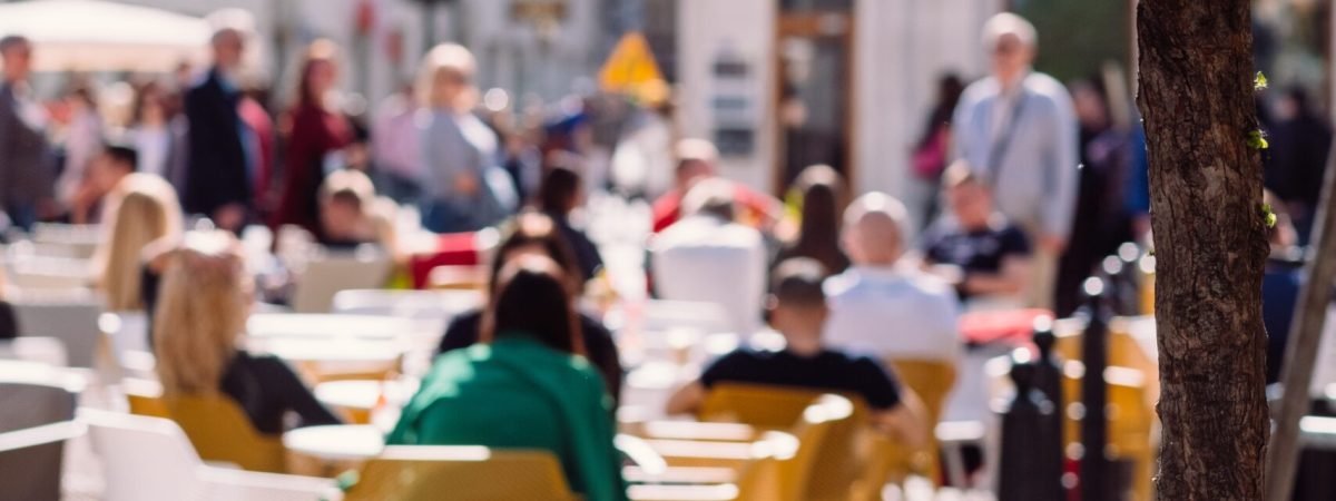 people sitting on brown wooden chairs during daytime