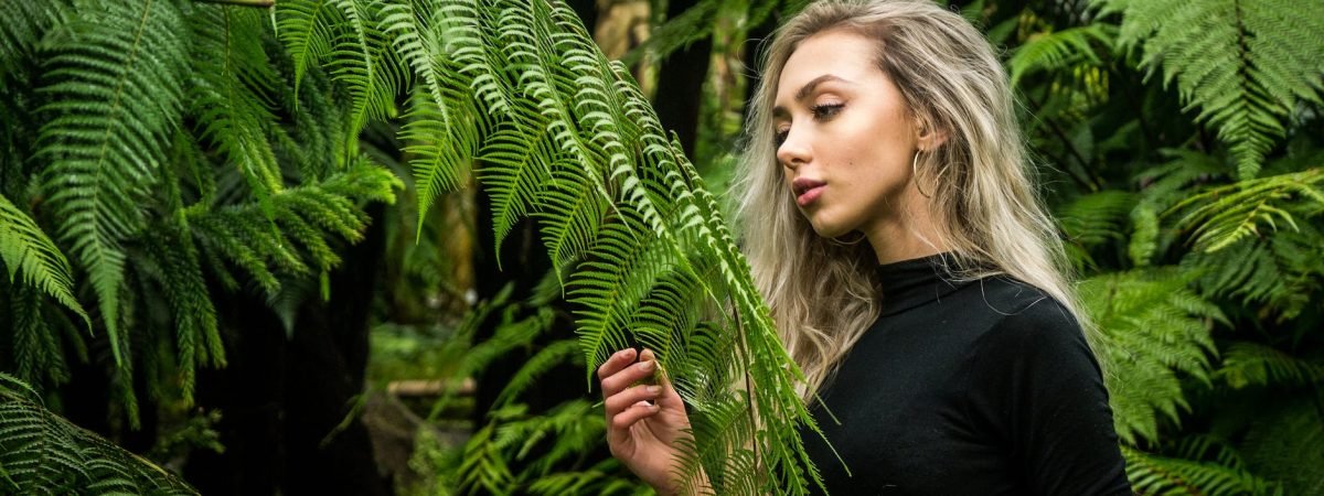 photo of girl holding fern