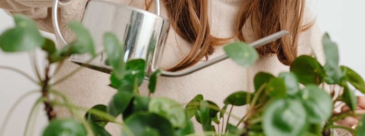 smiling woman watering plants