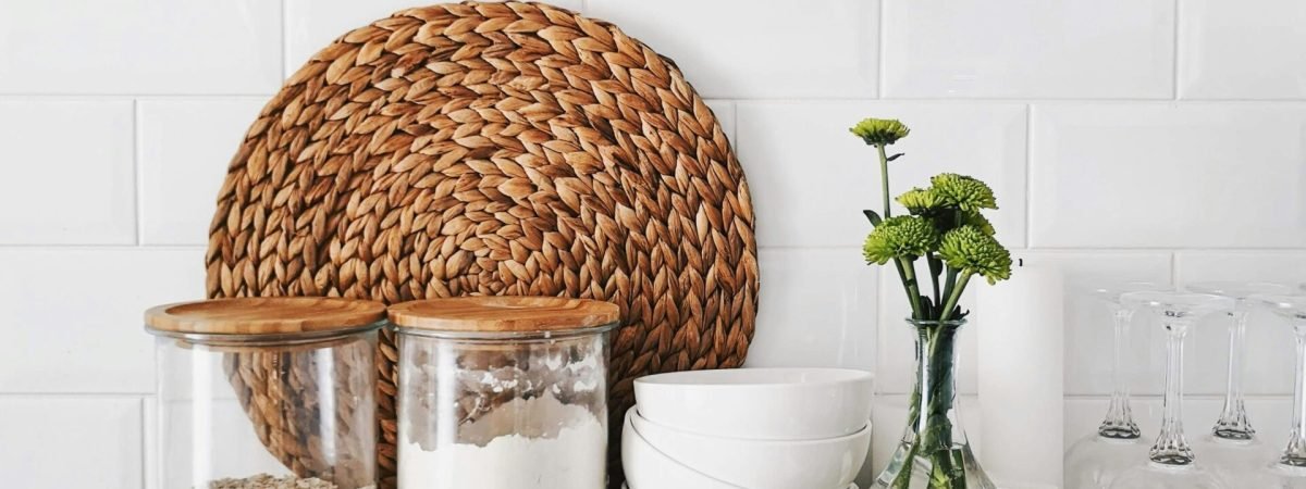 two clear glass jars on brown wooden floating shelf